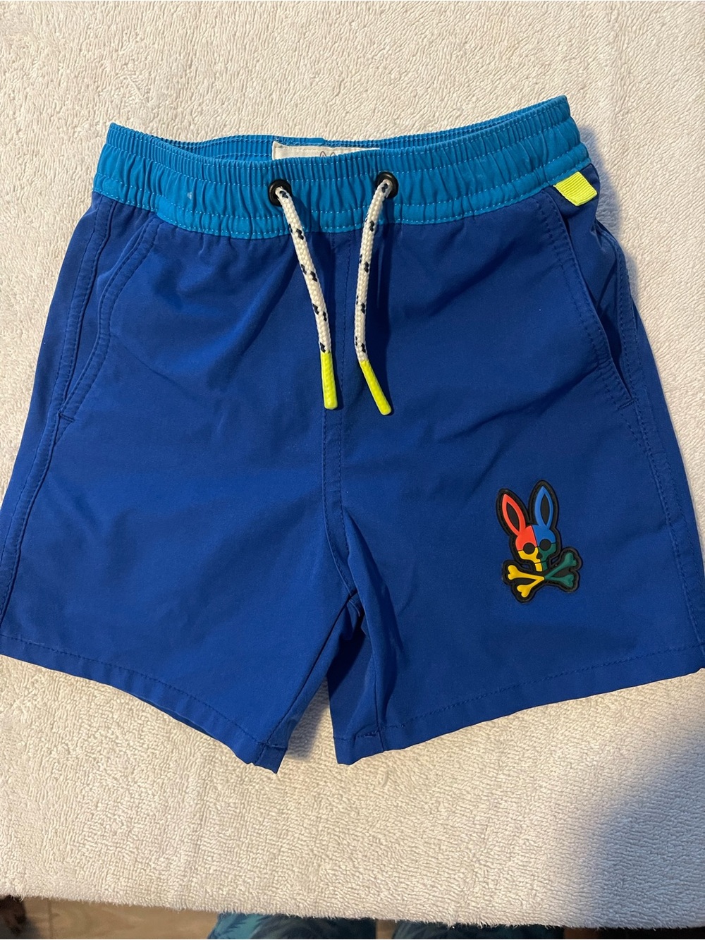 Psycho Bunny Royal Blue Kids Swim Shorts with Teal Waistband and Neon Accents -